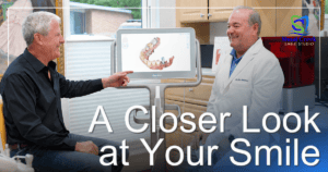 doctor showing scans to dental patient