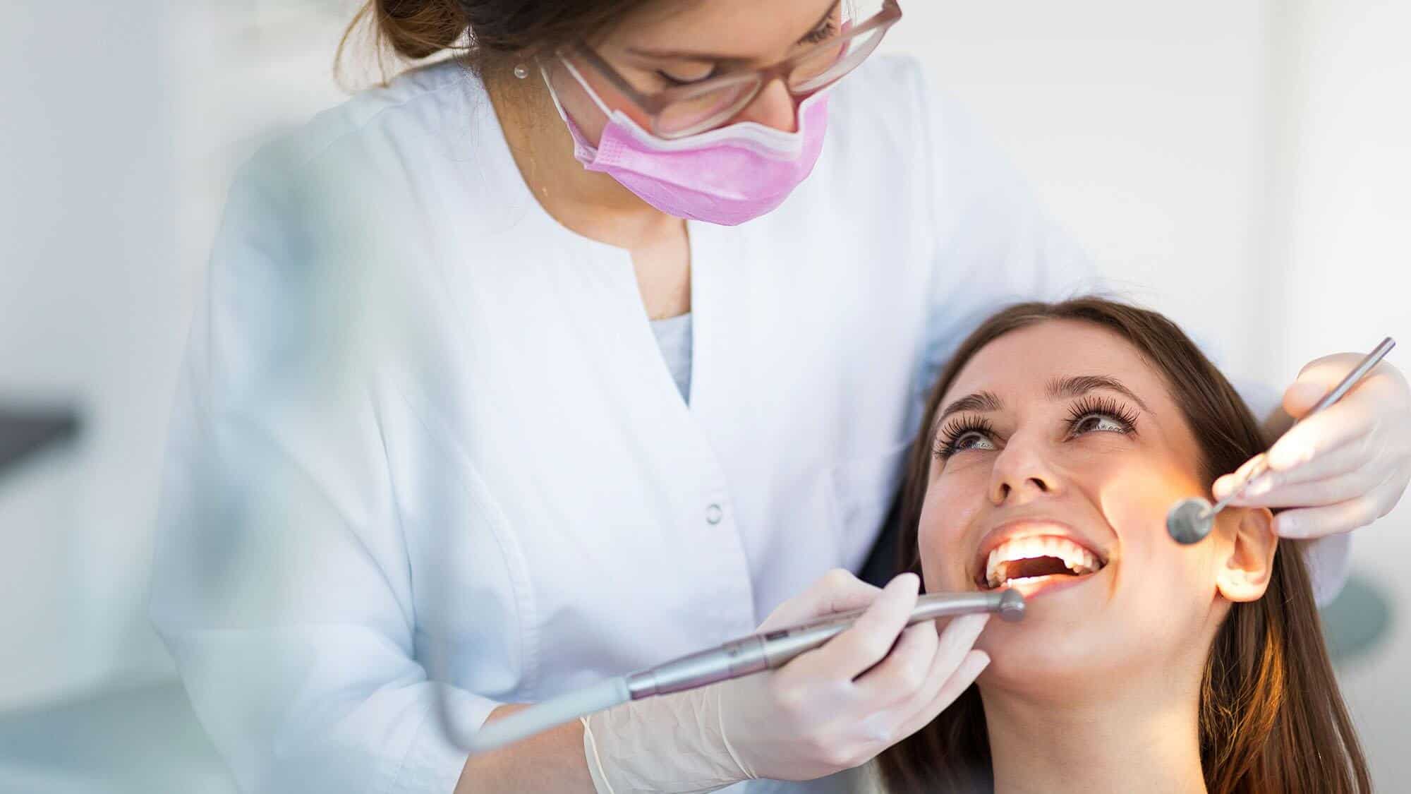 Woman cleaning by hygienist